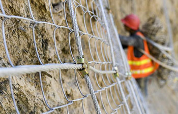 Men work on the cliff in China's Xinjiang